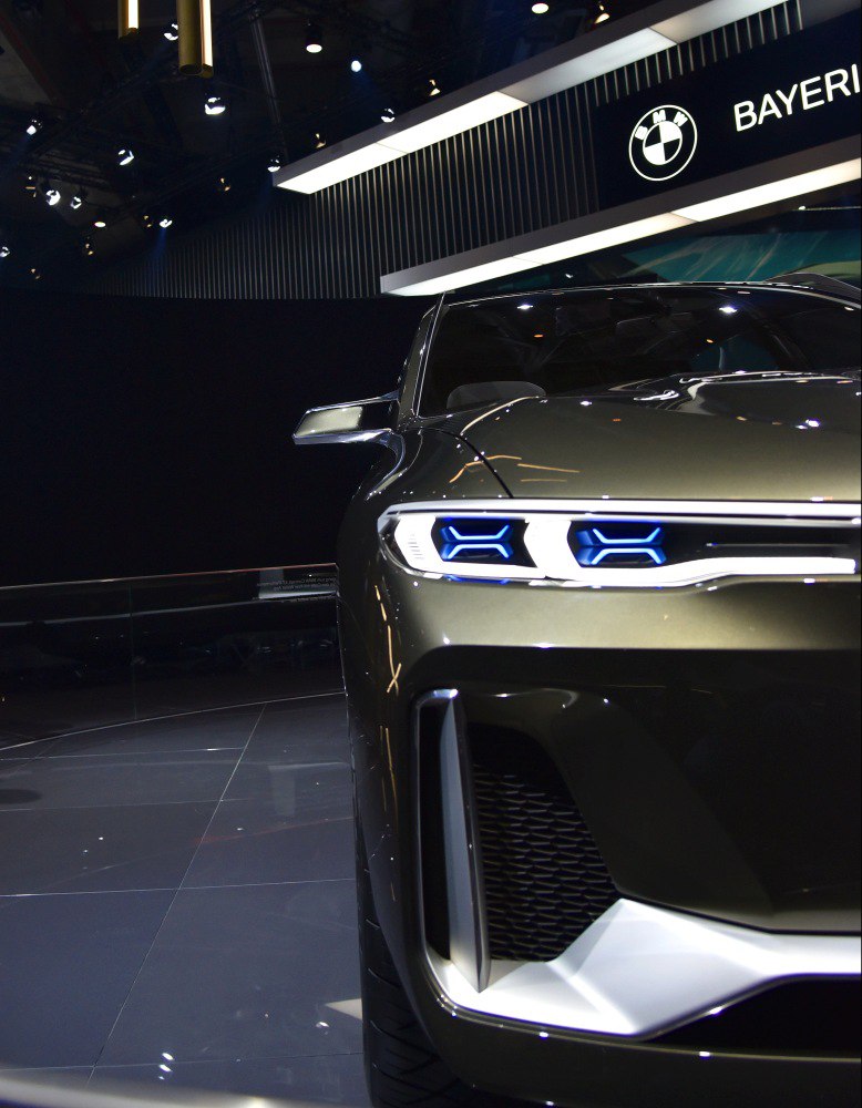 Close-up of futuristic LED headlights and bold front grille design