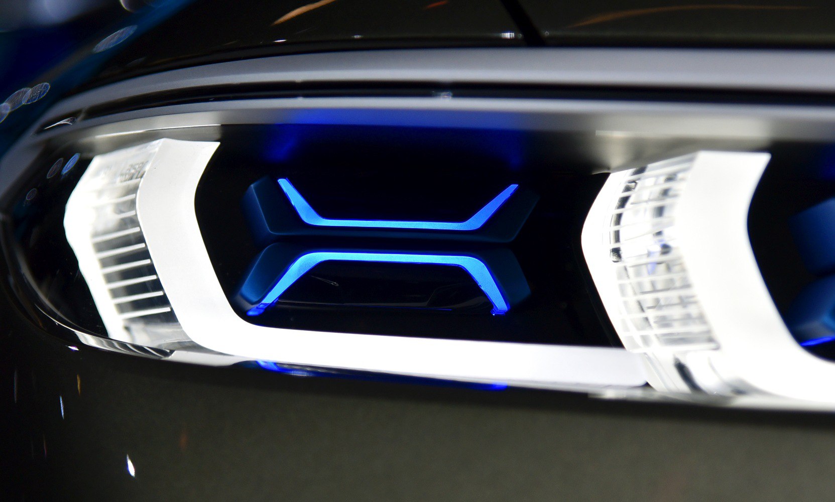 Close-up of futuristic LED headlight with blue lighting elements