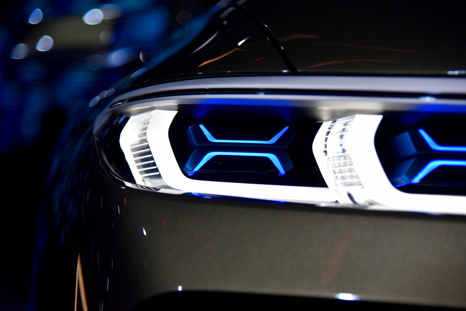 Futuristic LED headlight with blue accents and distinct shapes