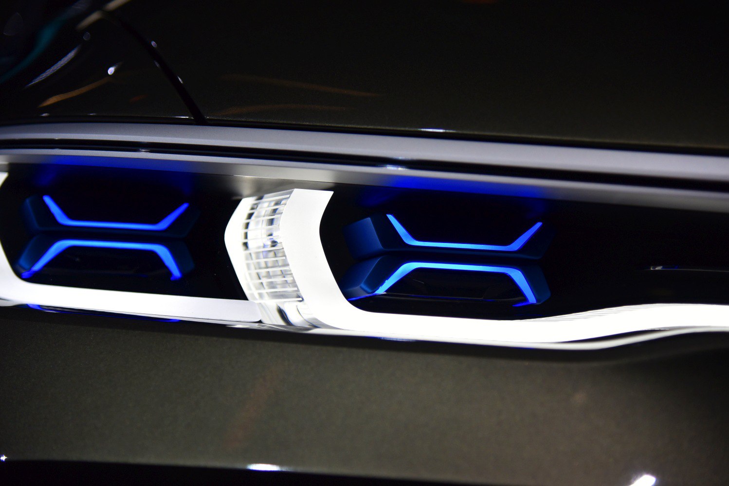 Illuminated blue LED front grille detail with futuristic design elements