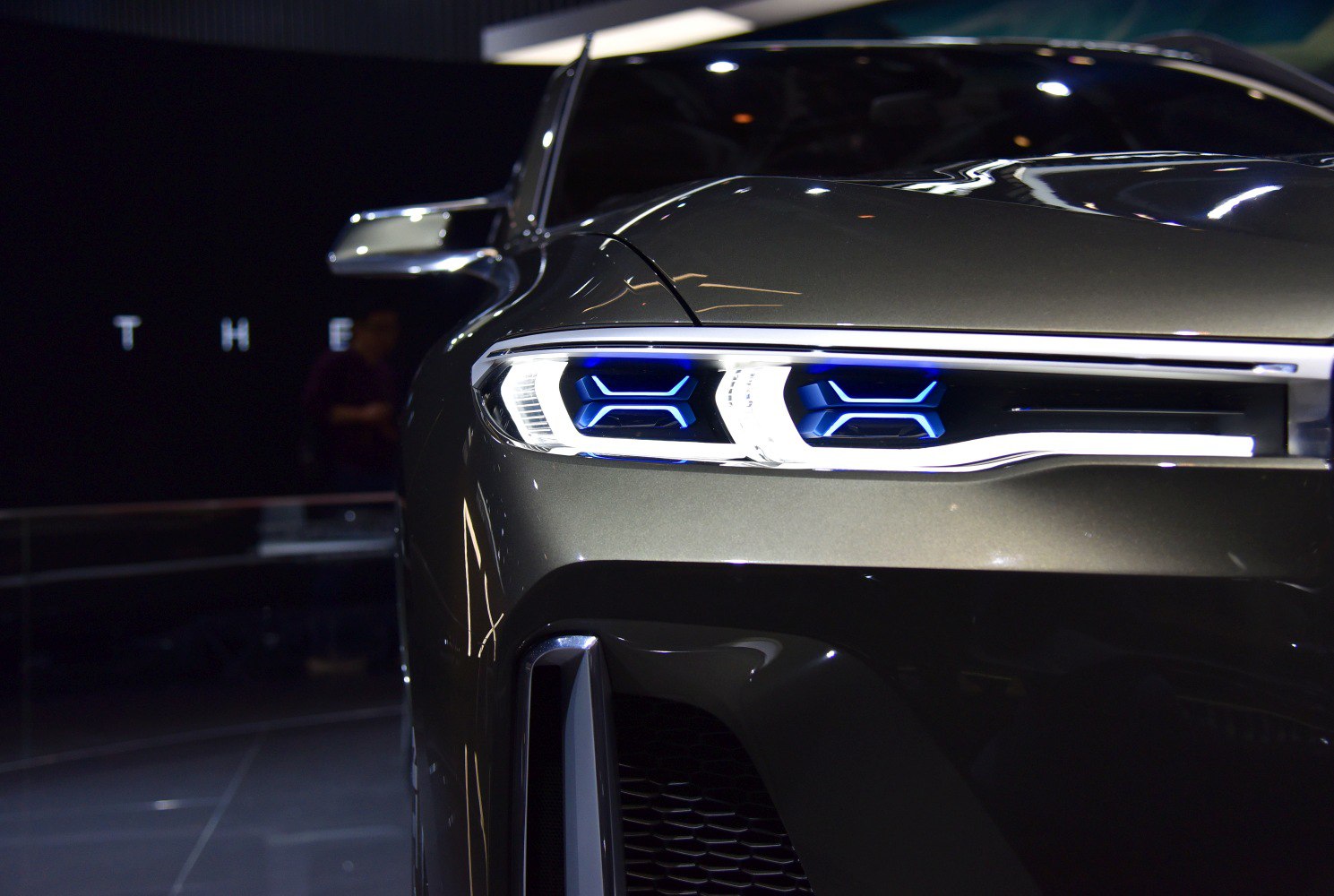 Close-up of futuristic front LED headlights with blue lighting elements