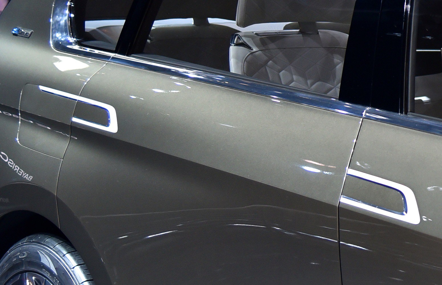 Close-up of rear door with unique handle and quilted interior seat