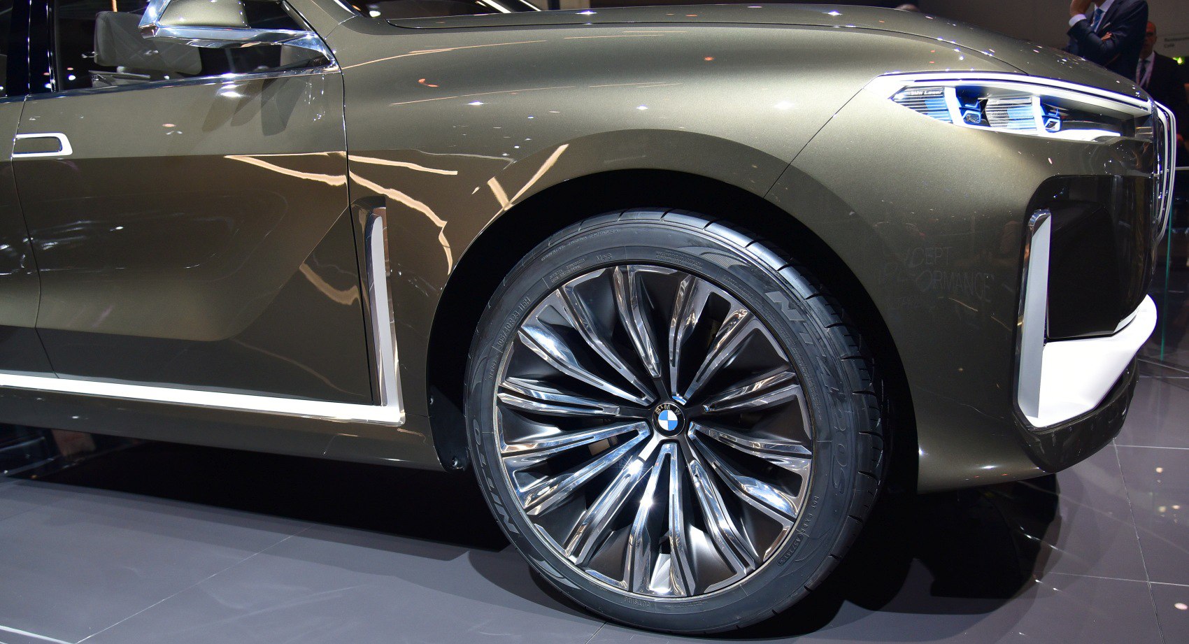 Large alloy wheel with intricate design and modern front headlight