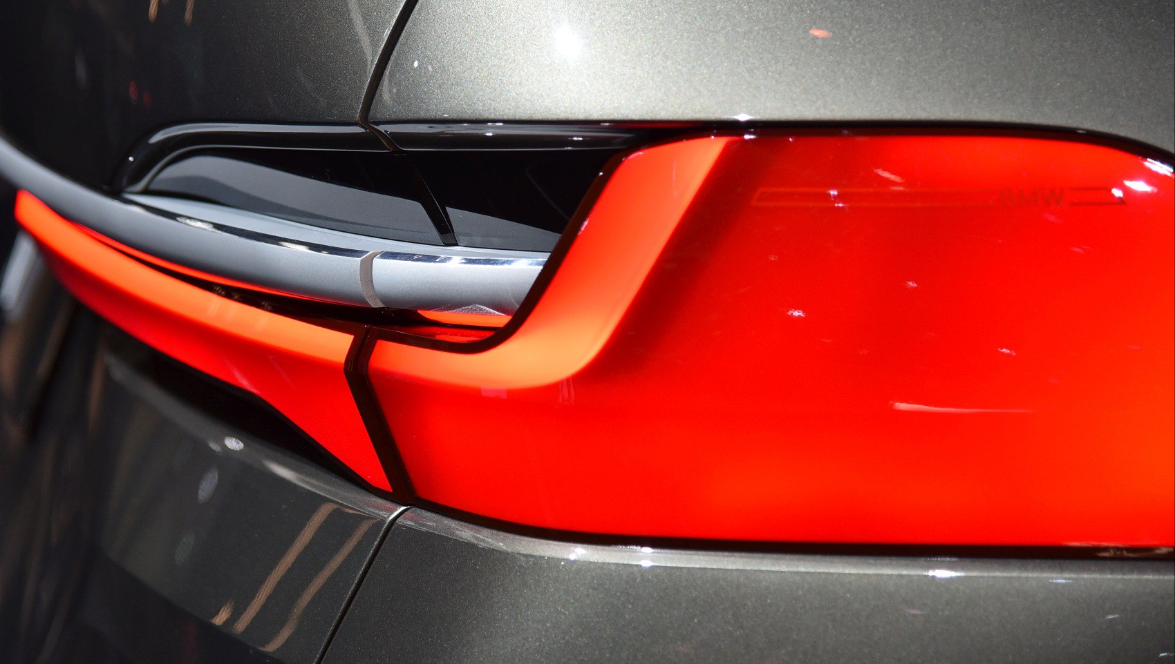 Close-up of vibrant red rear light and nearby body design.