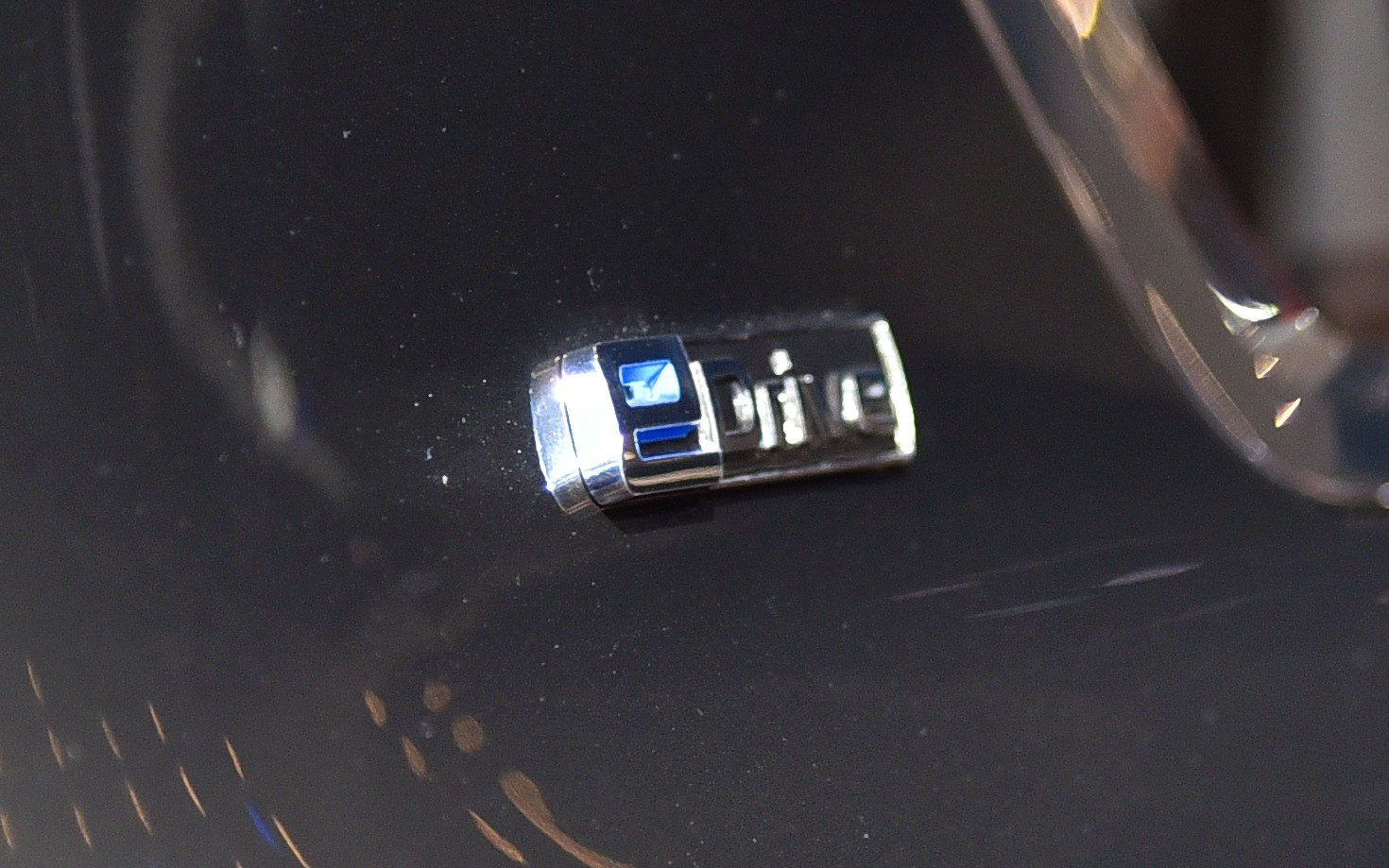 Close-up of xDrive badge on a black surface