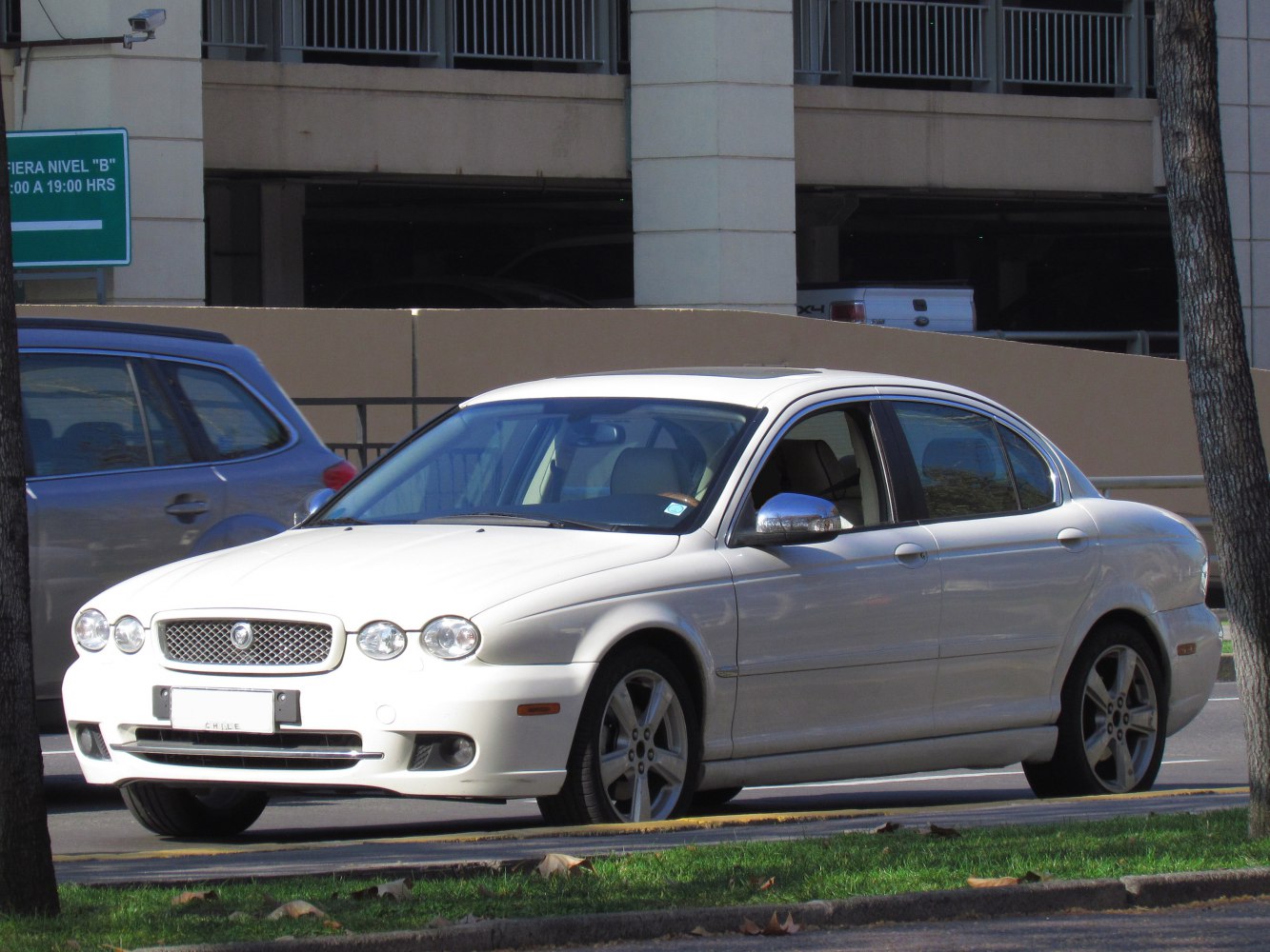 White sedan front side view with round headlights and sleek body design