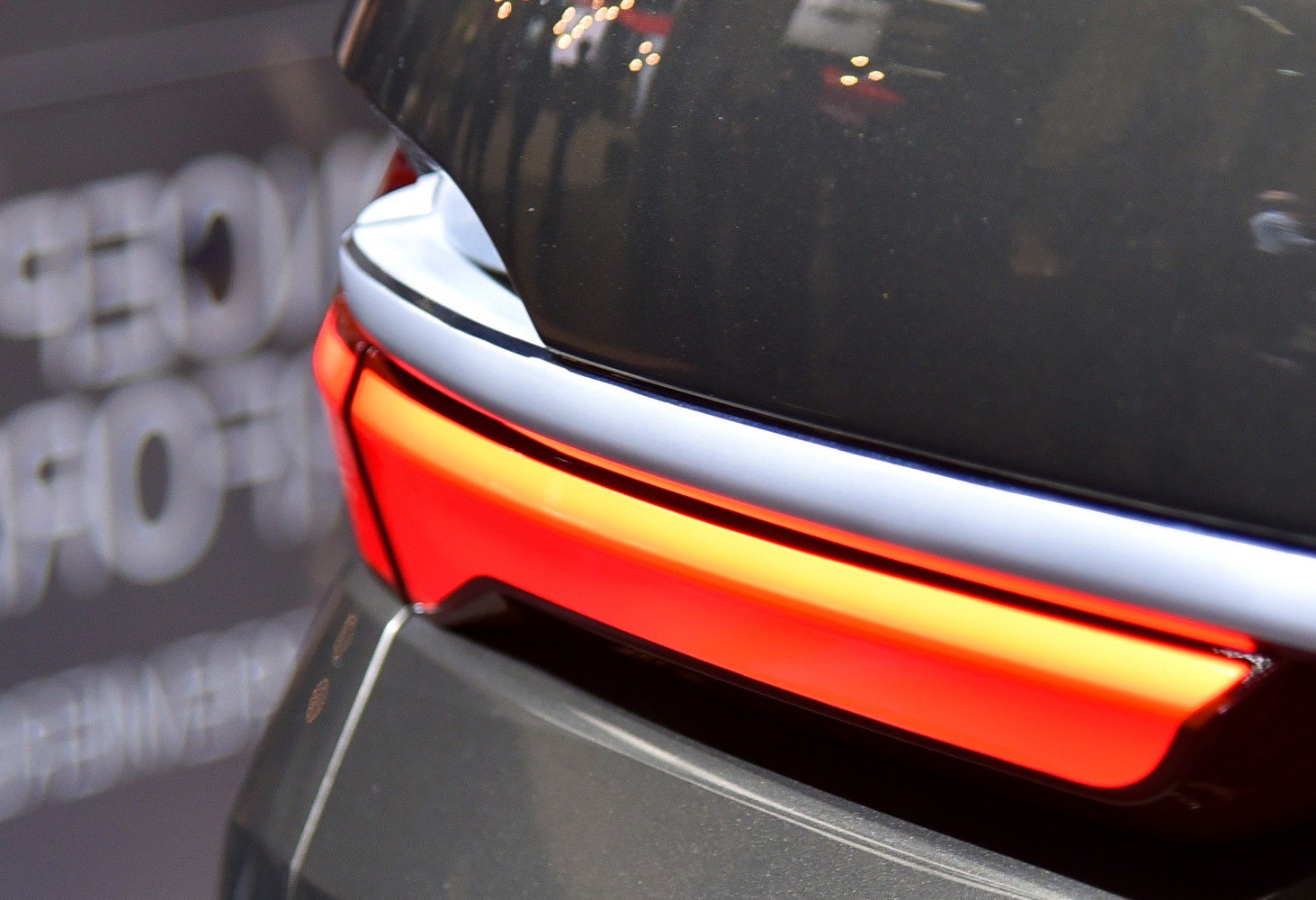 Close-up of a modern rear tail light with illuminated horizontal design