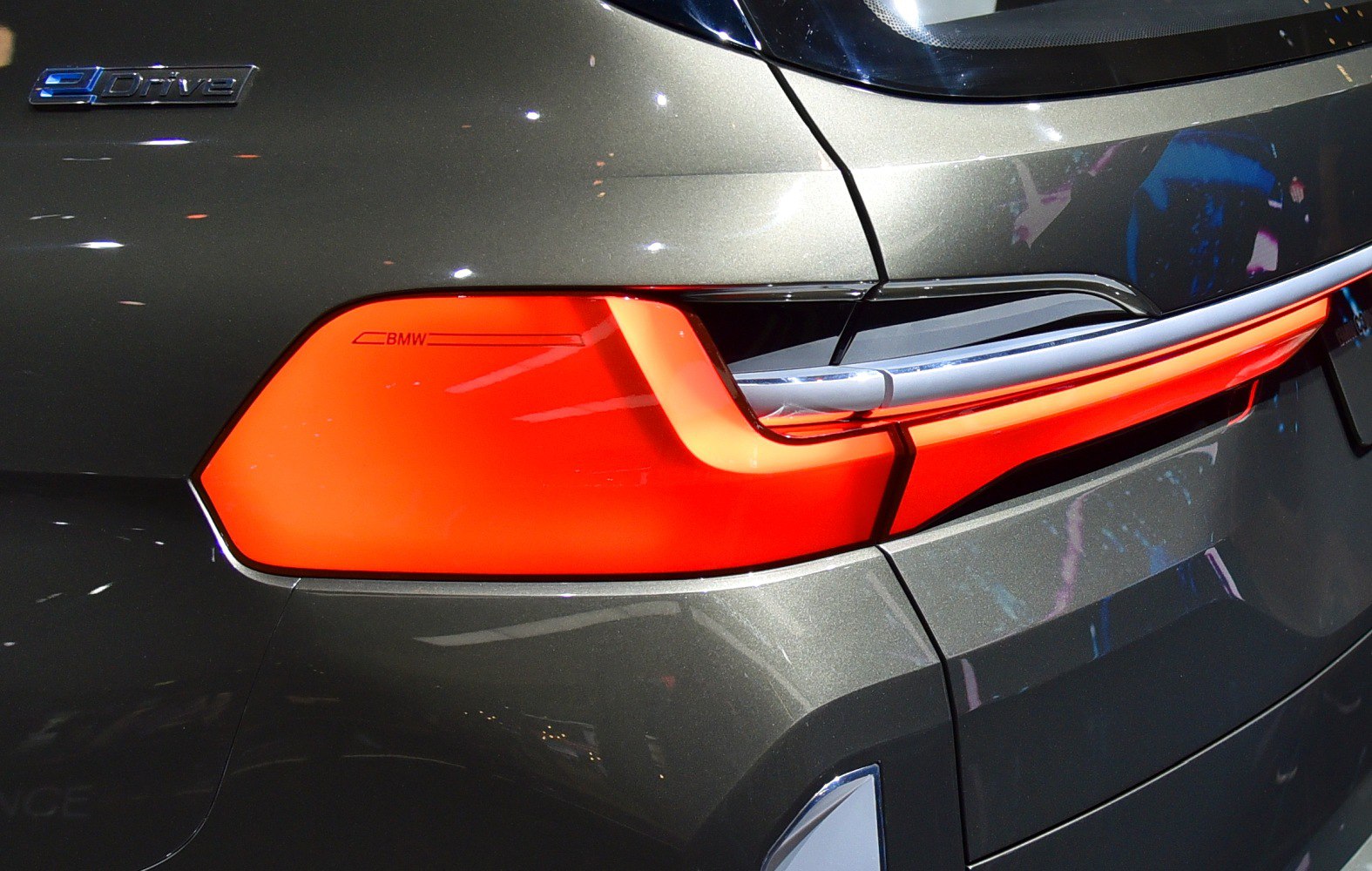 Rear tail light and eDrive badge close-up on modern vehicle.