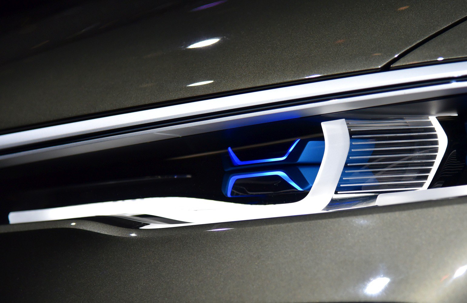 Close-up of illuminated front grille with blue light accents