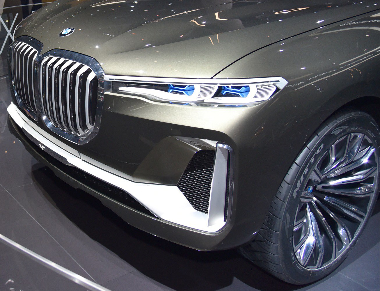 Close-up of front grille and blue-accented LED headlights