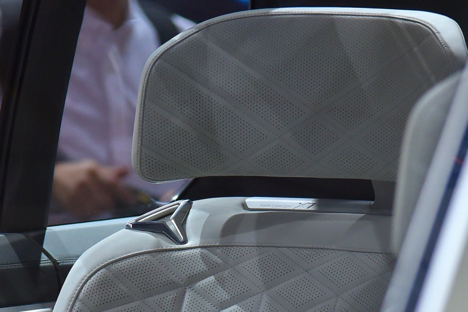 Perforated leather headrest with diamond stitching and concept badge