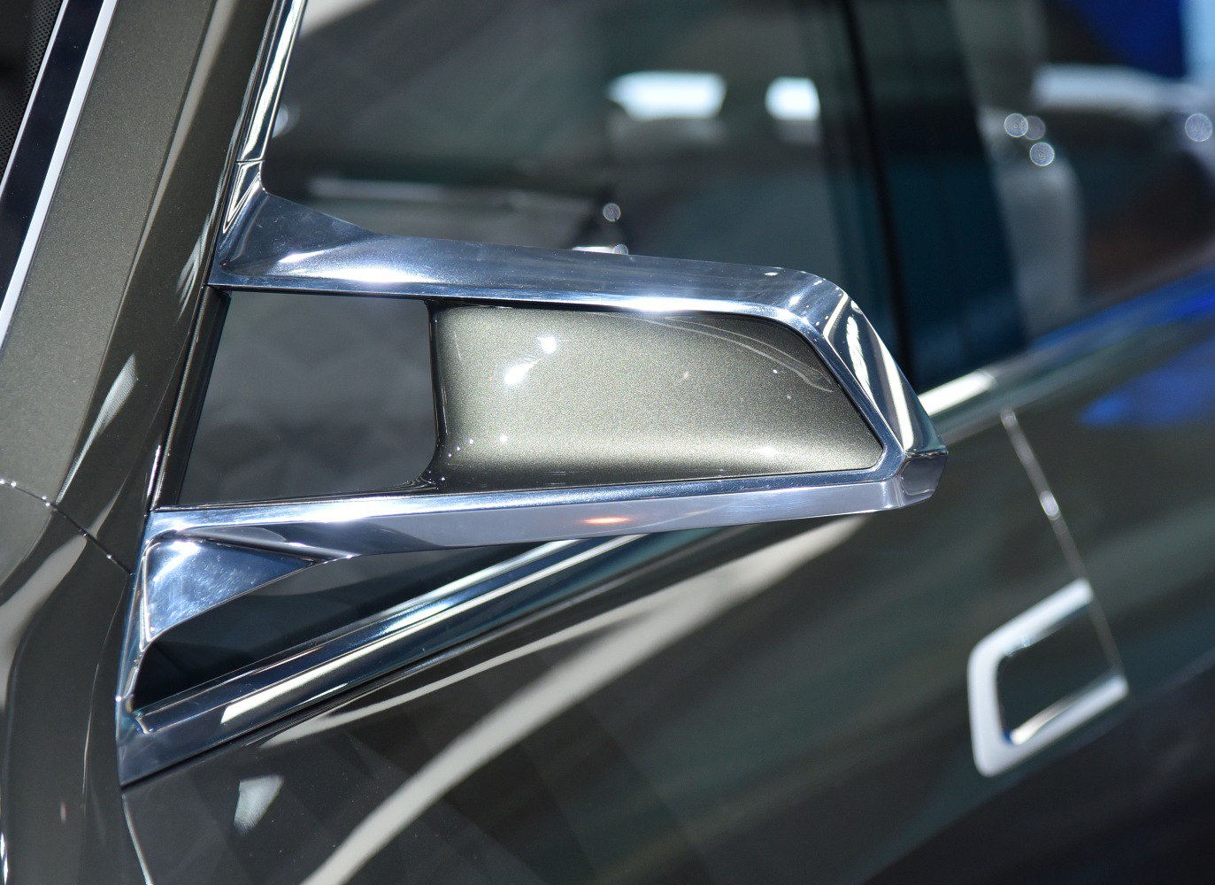 Close-up of chrome-accented side mirror on luxury SUV