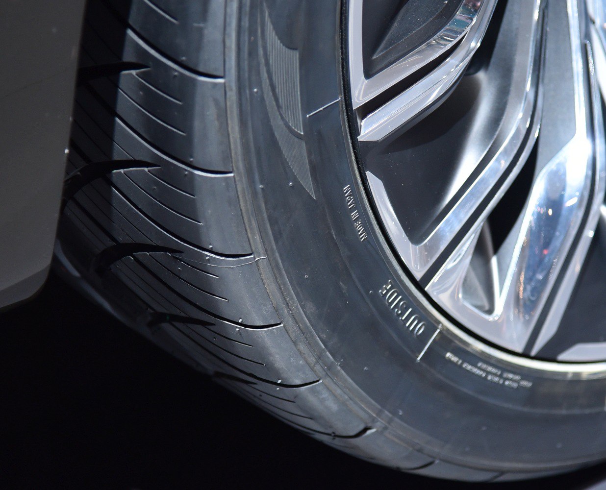 Close-up of wheel rim and tire tread pattern