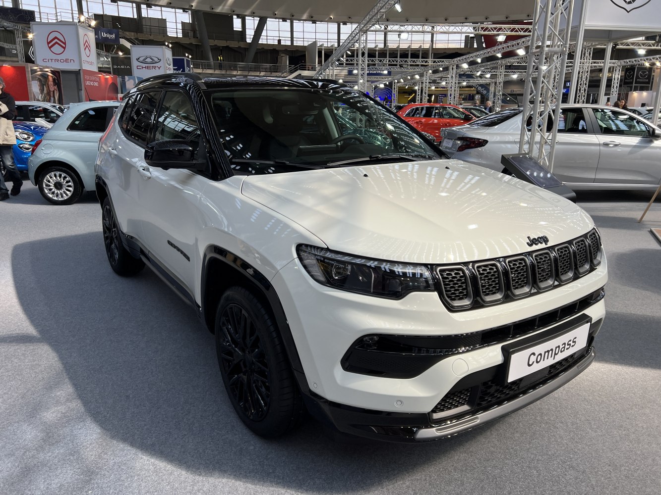 Front three-quarter view showing black roof and grille design