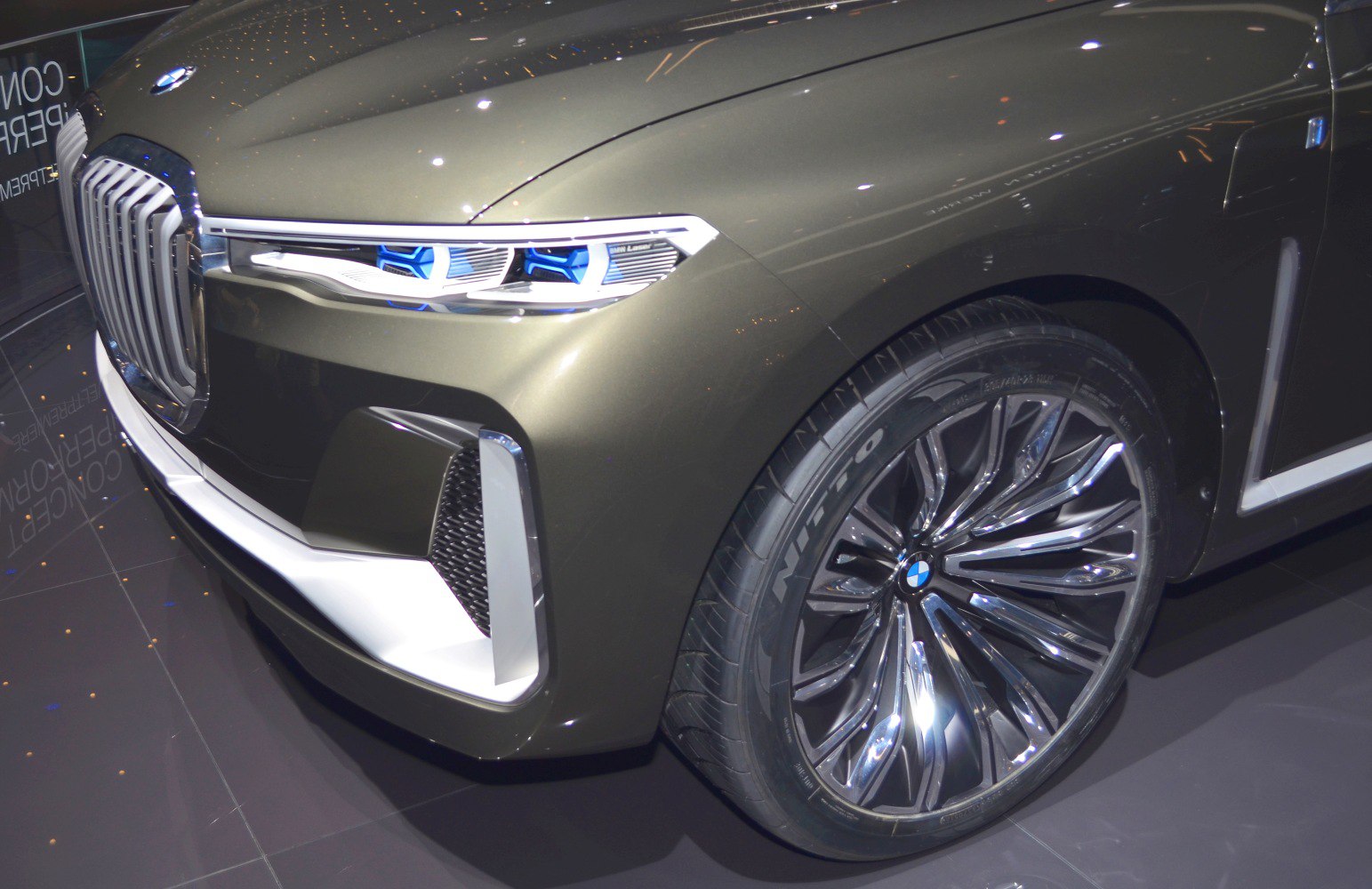 Front grille with blue-accented headlights and alloy wheel detail