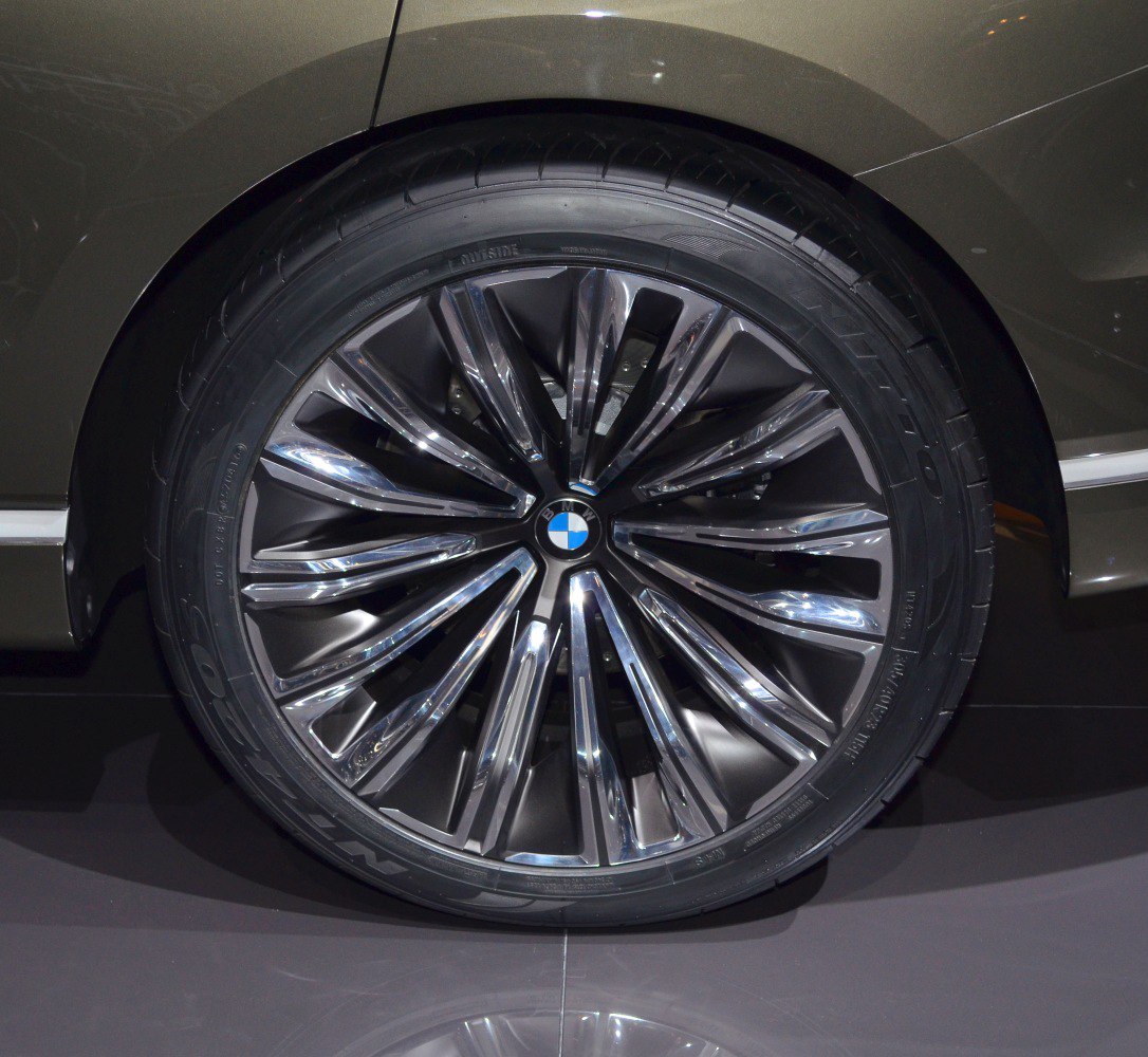 Intricate alloy wheel with multi-spoke design and premium tire.