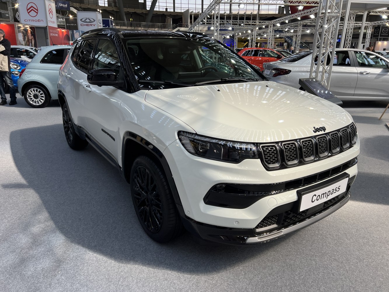 Sleek front and side view with LED headlights and two-tone black roof.