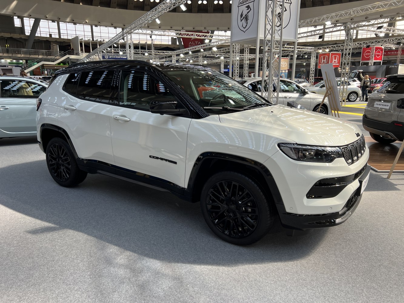 White SUV with black roof, black wheels, and sleek black trims