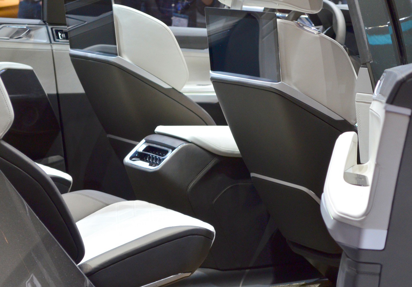 Luxury rear seats with integrated screens and climate control panel