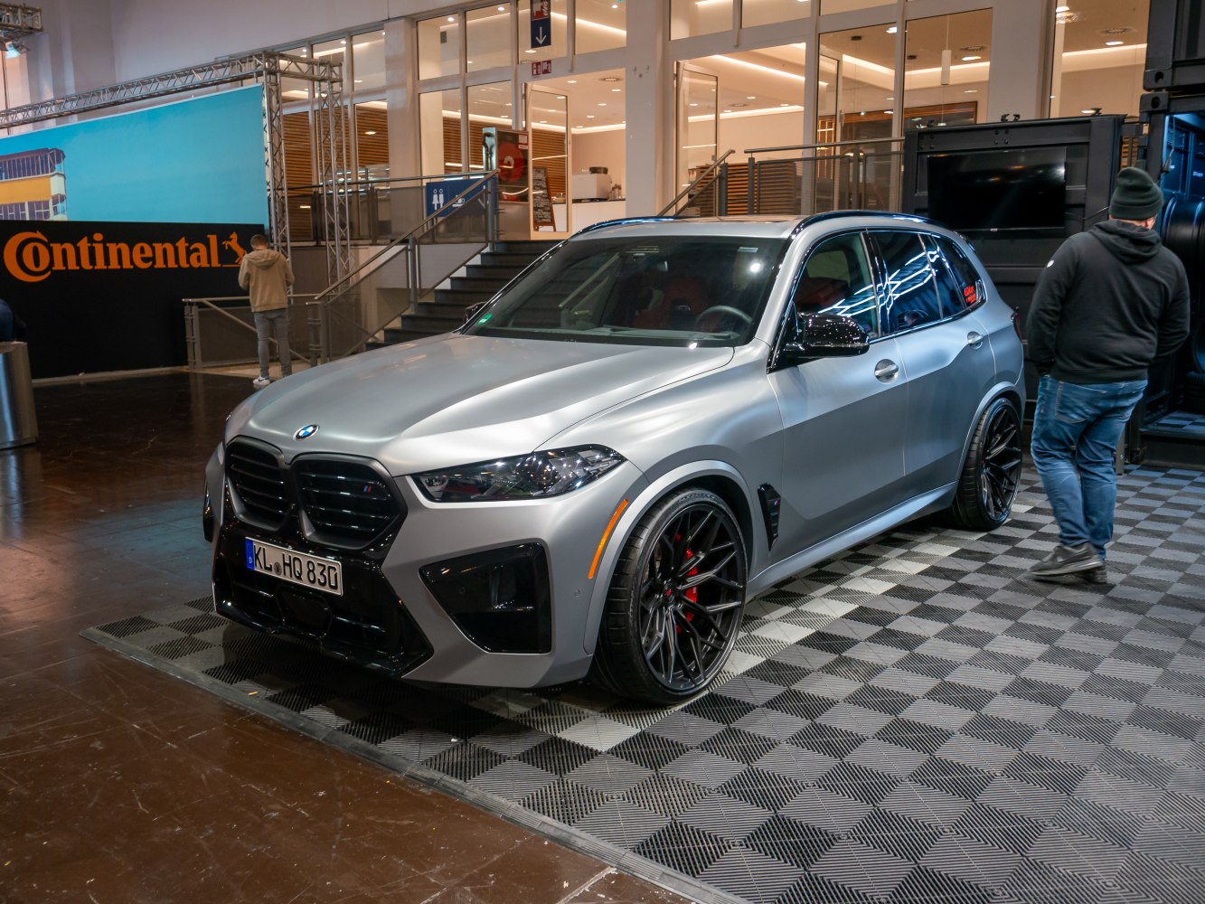 Matte silver SUV with black multi-spoke wheels and aggressive front grille