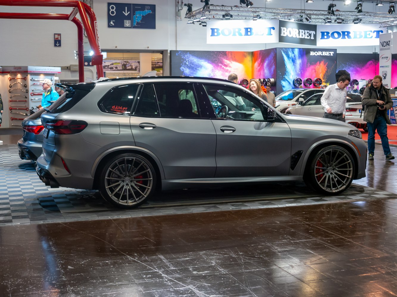 Sport SUV side view with matte grey paint and large alloy wheels.