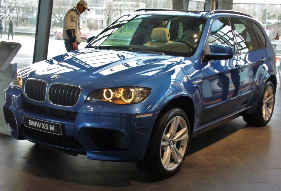 Blue luxury SUV with distinctive angel eyes headlights