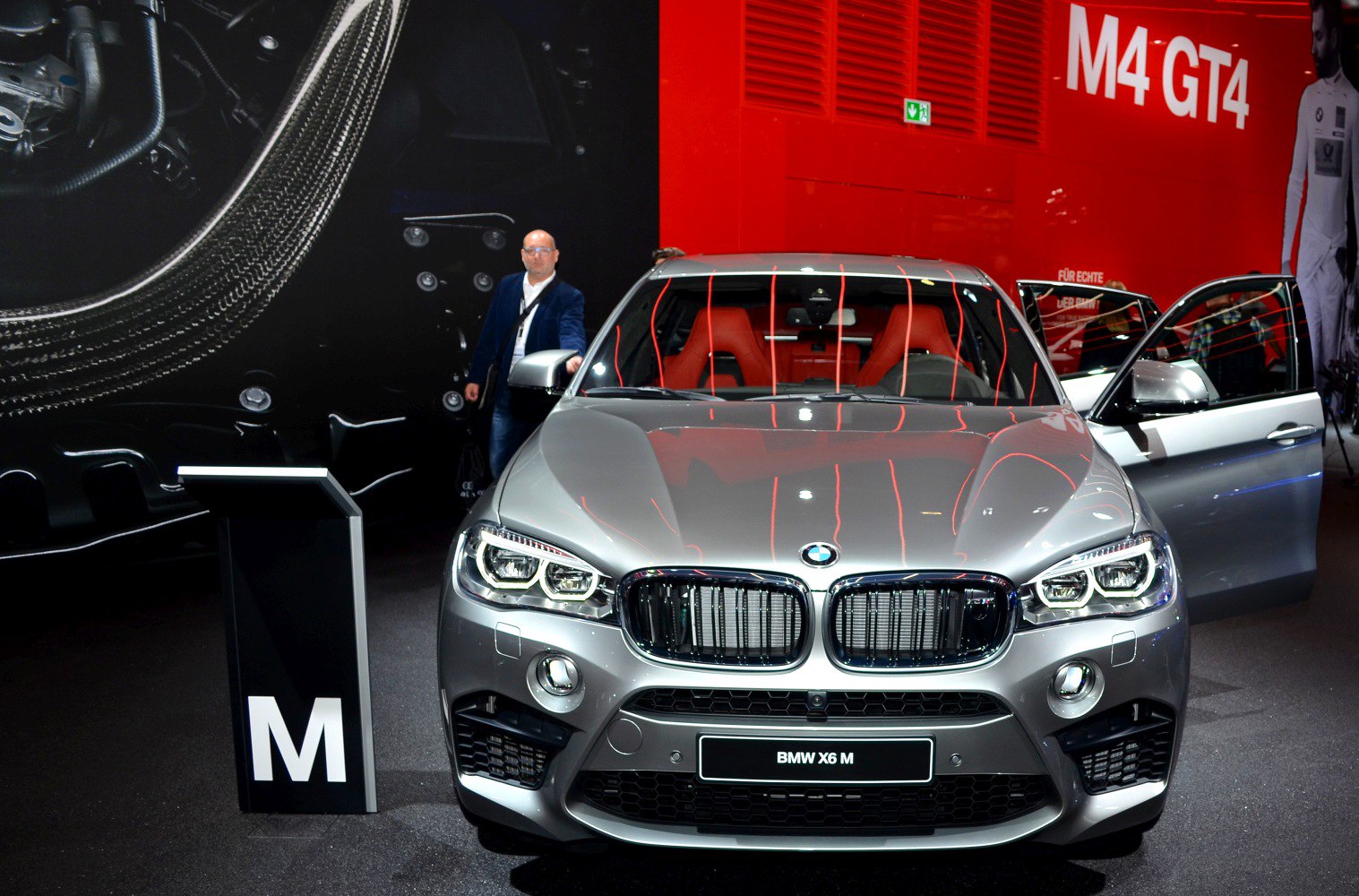 Front grille and LED headlights with open door and red interior seating