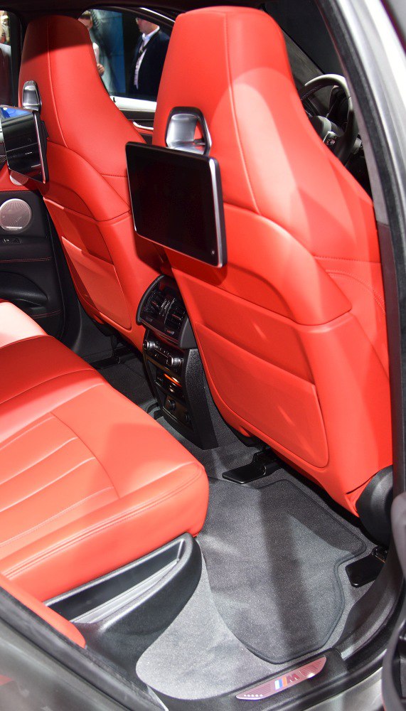 Rear seats with red leather upholstery and integrated entertainment screens