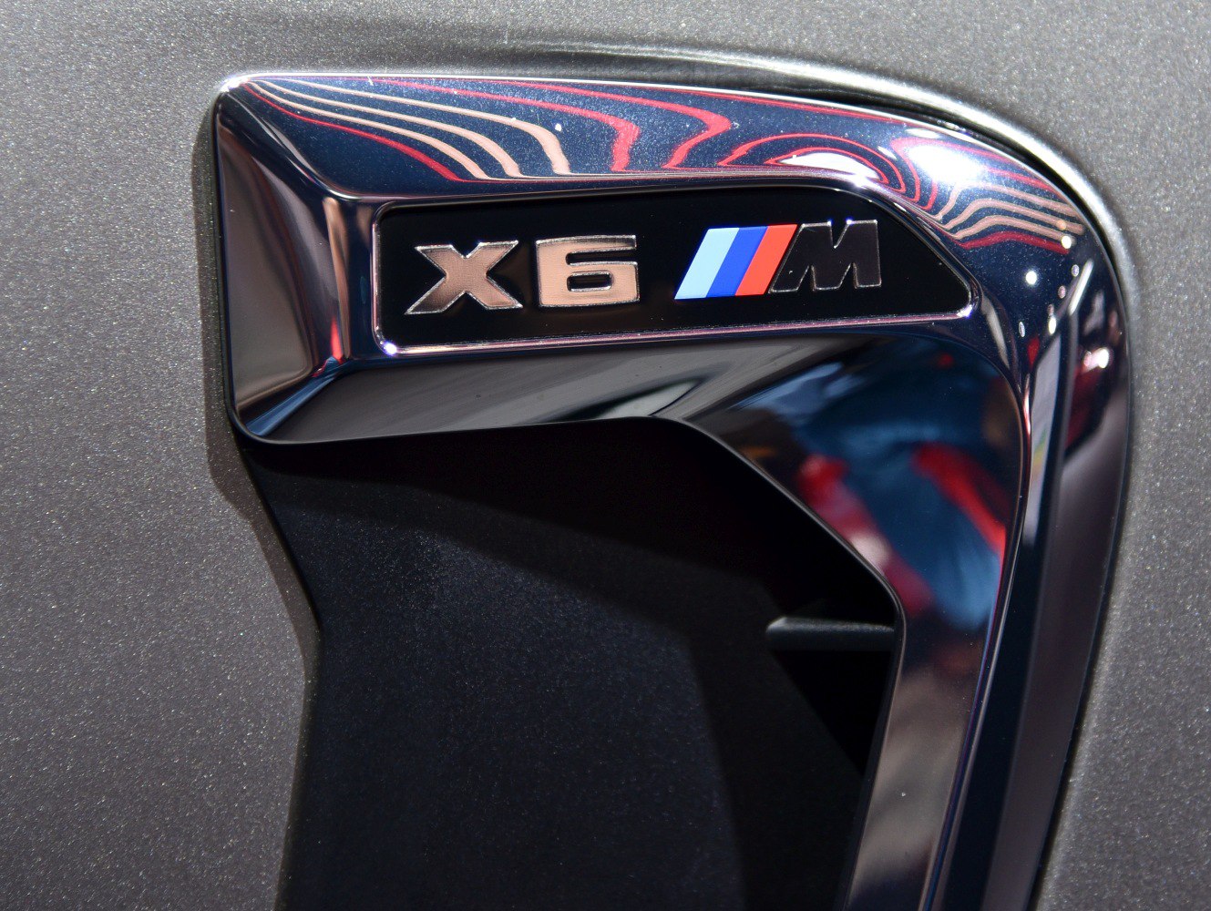 Close-up of BMW X6 M F86 side air vent with badge
