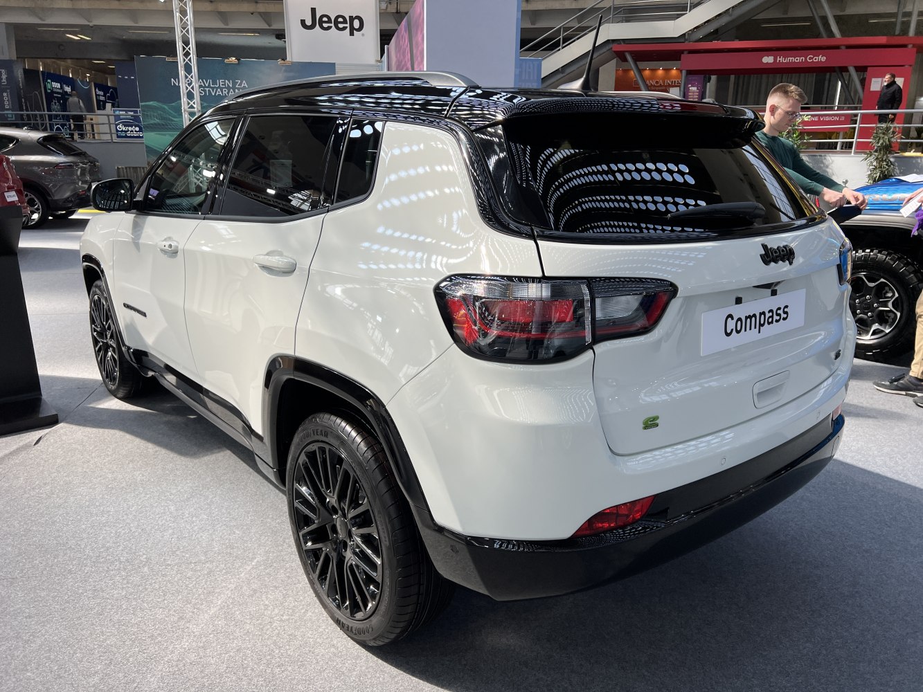 Rear side profile of a two-tone white and black SUV with modern taillights and sporty wheels