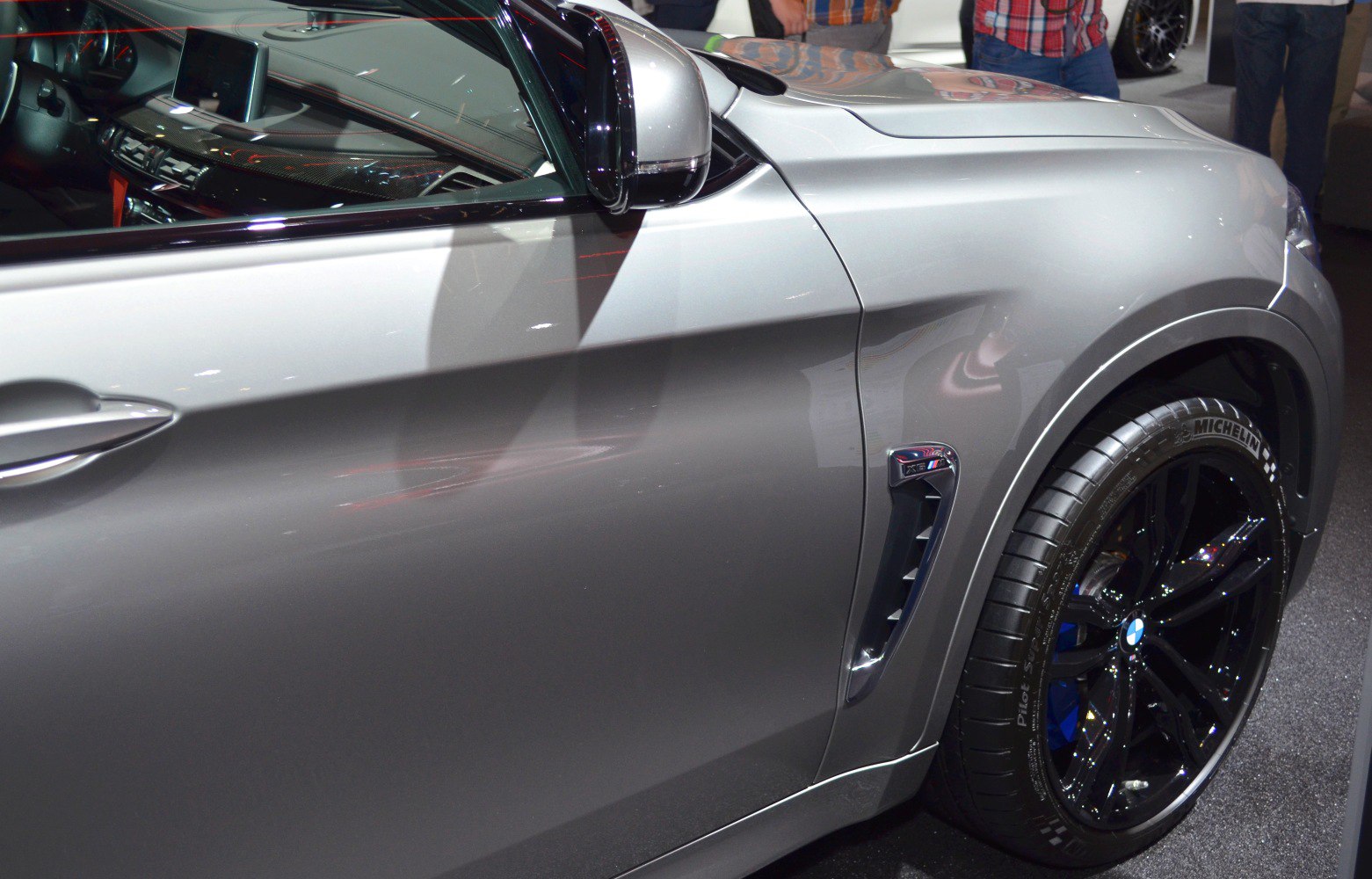 Close-up of side vent and black alloy wheel of a luxury sport SUV
