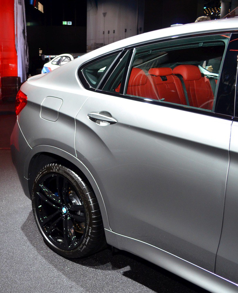 Silver SUV rear side with black alloy wheels and red leather seats