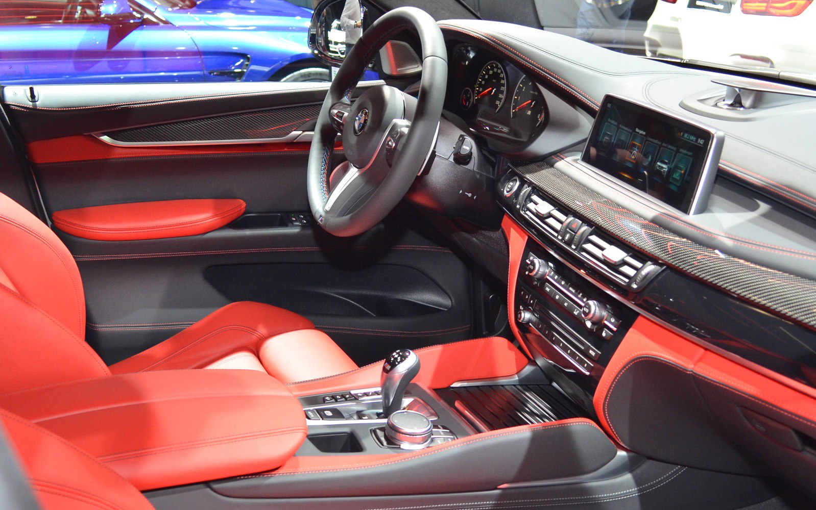 Red leather seats and carbon fiber dashboard trim in a luxury SUV interior