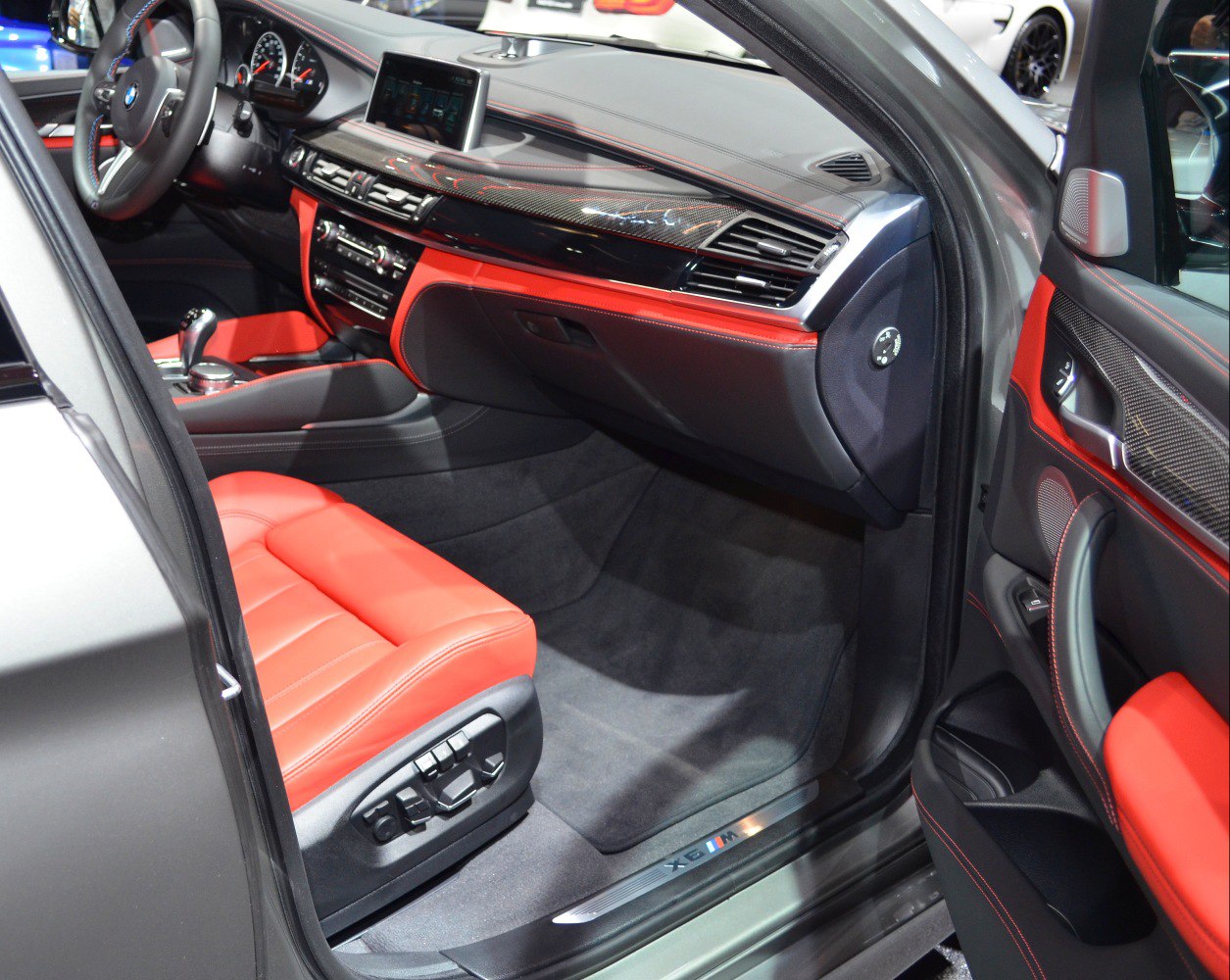 Red leather seats and carbon fiber dashboard trim with modern controls.