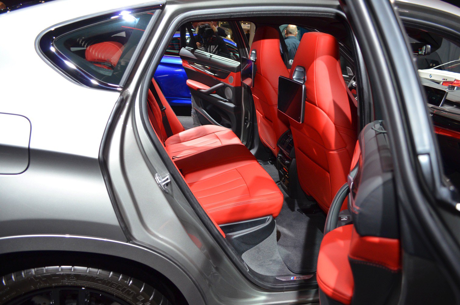 Red leather seats and rear entertainment screens inside a luxury SUV.