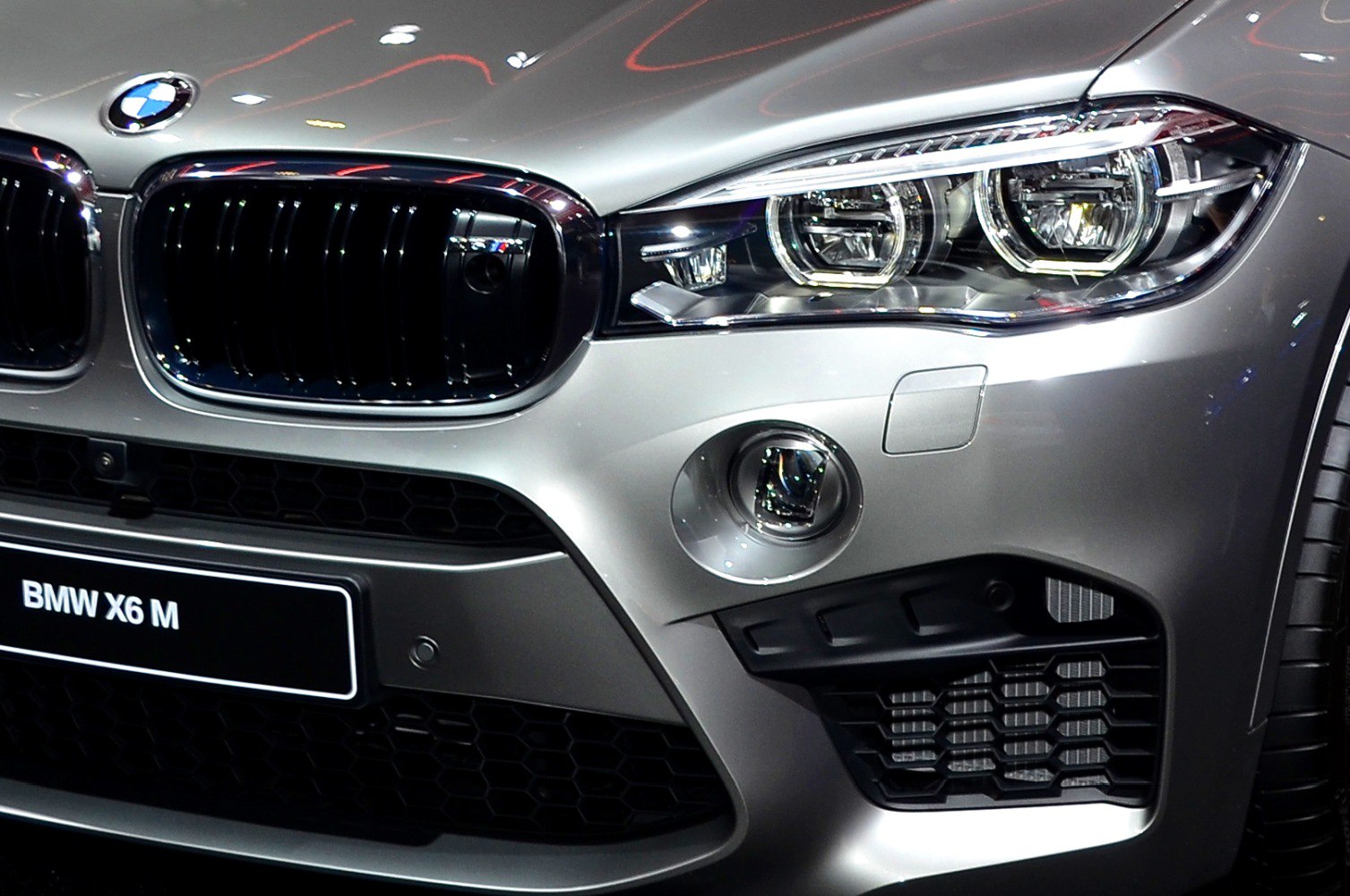 Close-up of front grille, dual headlights, and fog light