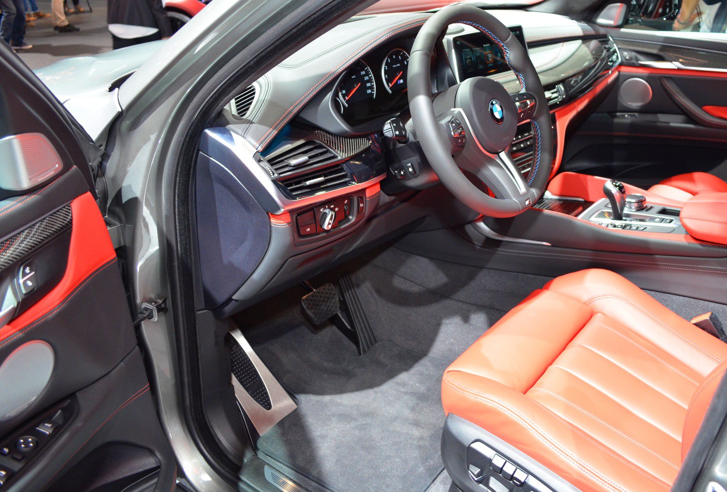 Sporty steering wheel and red leather seat with advanced dashboard