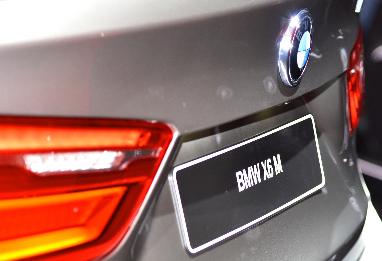 Close-up rear tail light and BMW badge on a luxury SUV.
