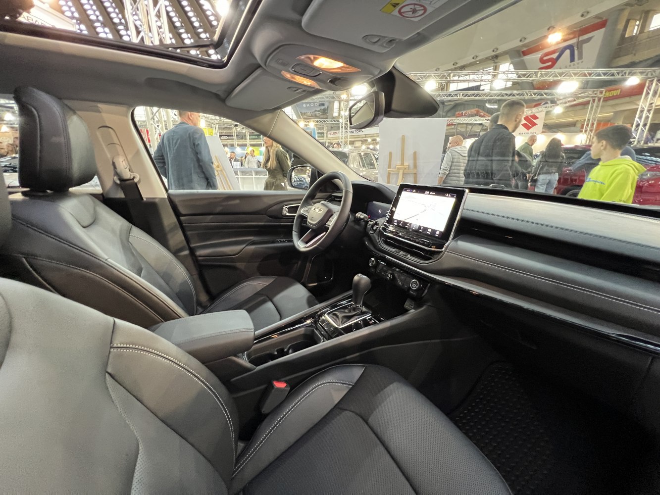 Modern car interior with dashboard touchscreen and panoramic sunroof
