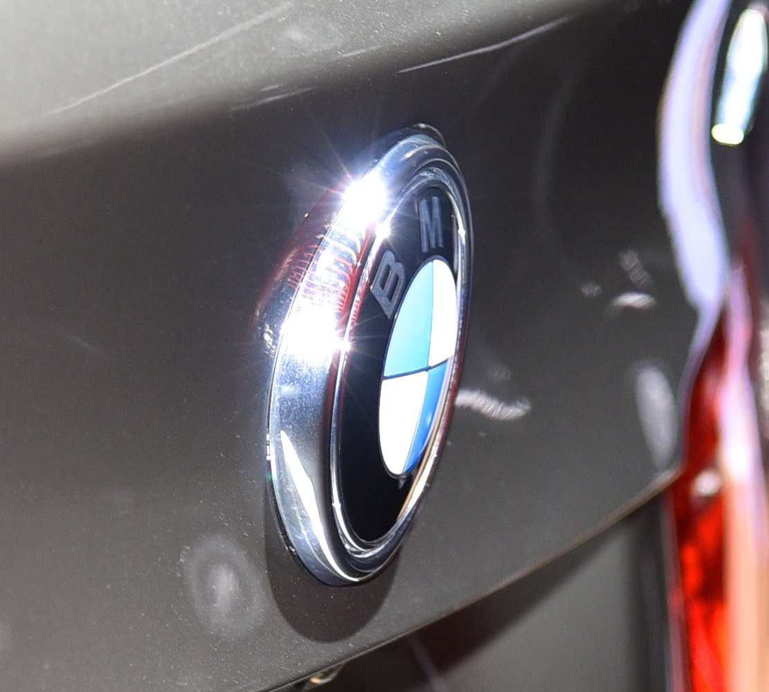 Close-up of BMW roundel badge on car surface