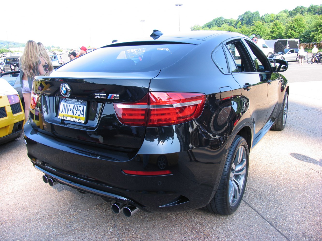 Rear view with quad exhausts and distinctive tail lights.