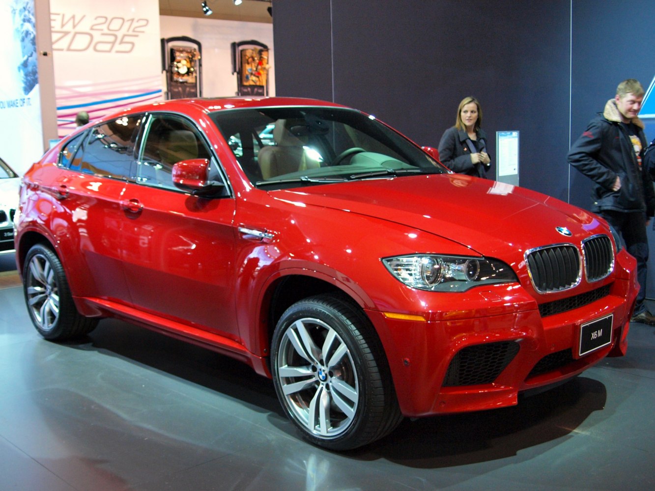 Red performance SUV with aggressive front and sporty alloy wheels