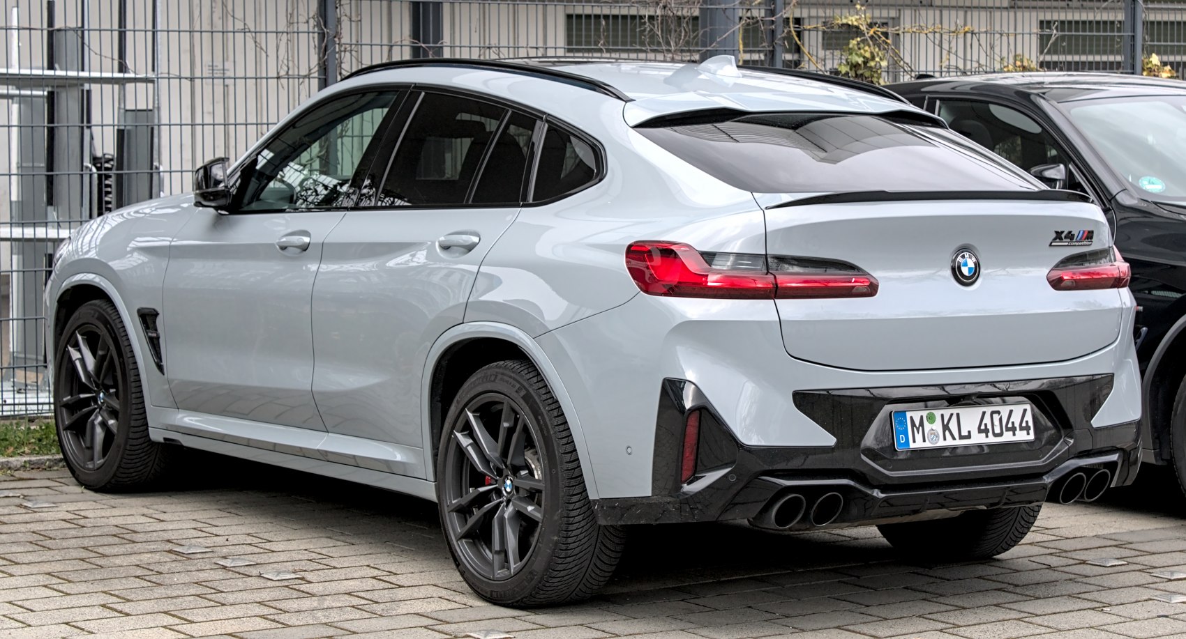 Rear view of a sporty SUV with quad exhaust and black wheels