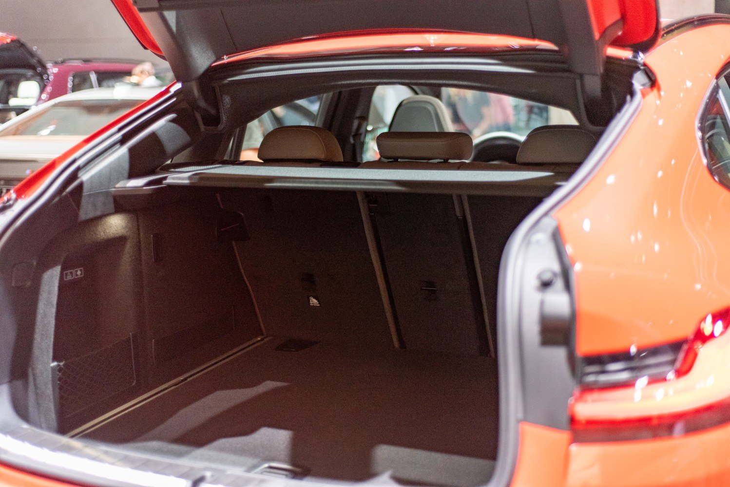 Open rear cargo trunk of an SUV with visible seats and spacious interior