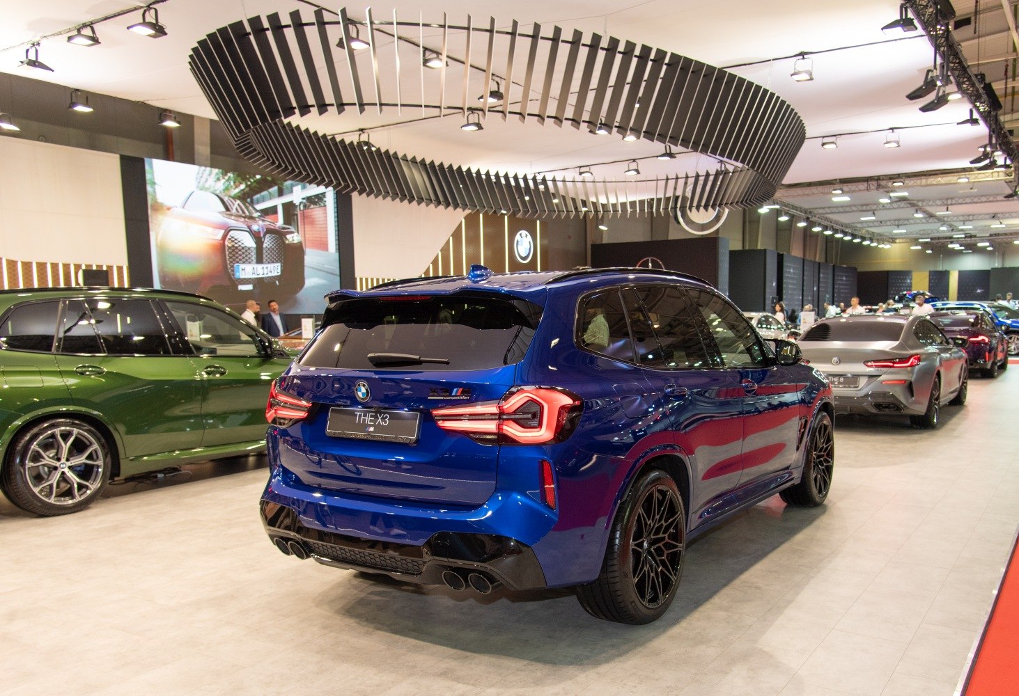 Rear and side view of an SUV with quad exhaust and distinctive taillights
