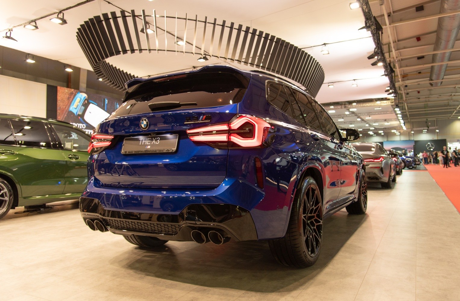 Rear view of a blue SUV with LED taillights and quad exhaust tips