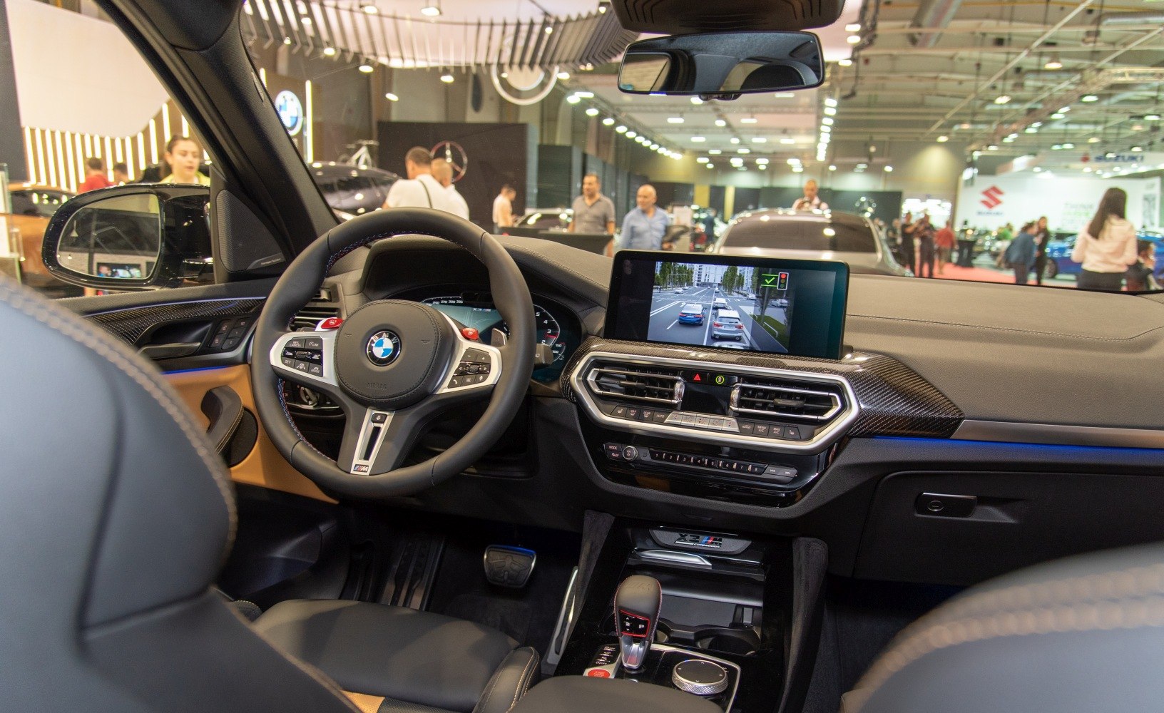Modern SUV interior with digital dashboard, steering wheel controls, and infotainment display.