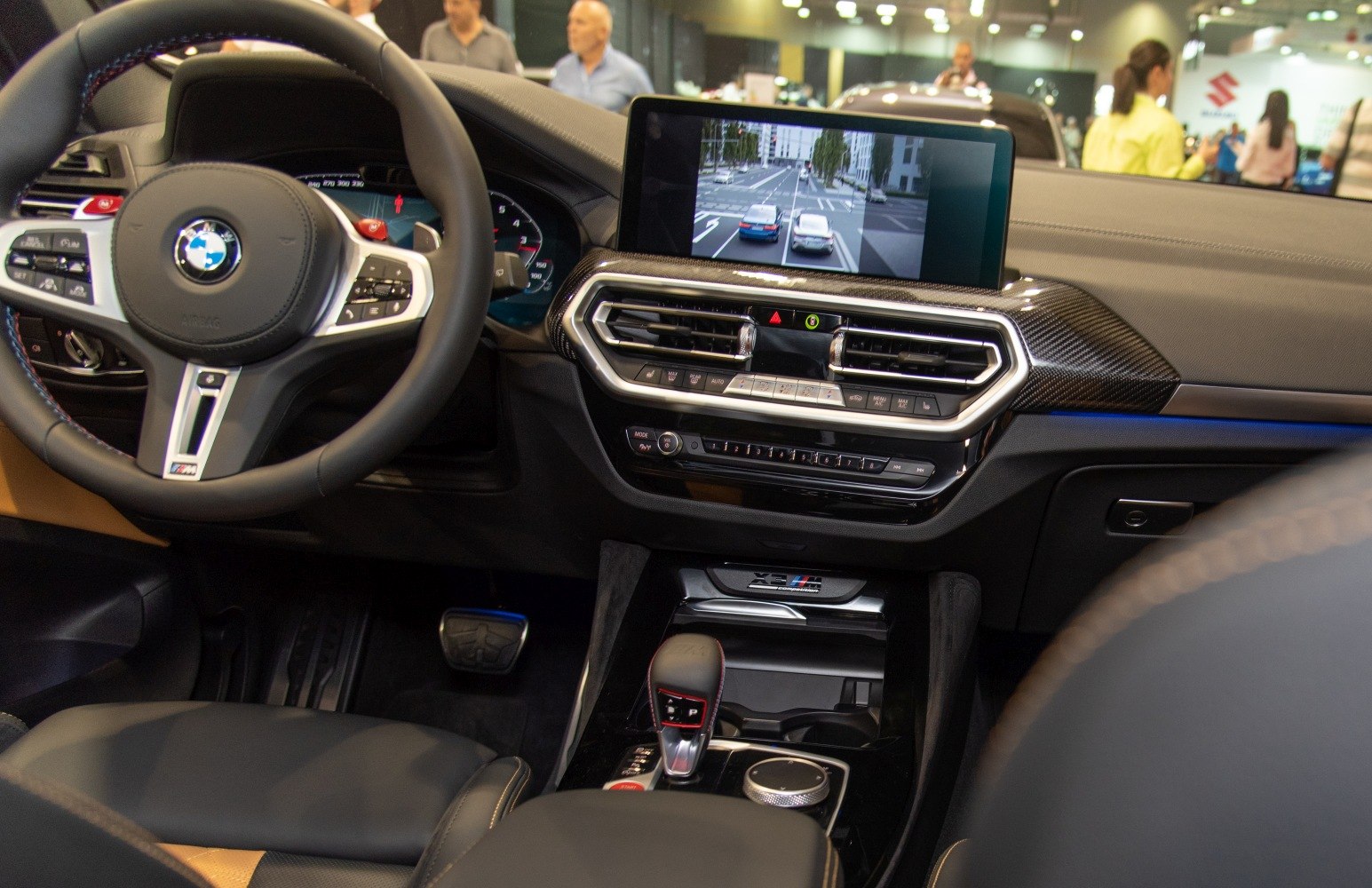 Dashboard, steering wheel, infotainment screen, gear shifter, climate control