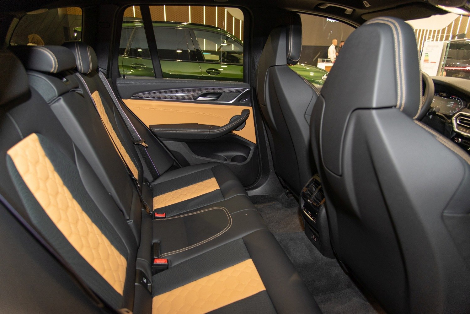Luxury two-tone leather rear seats and modern door panel design.