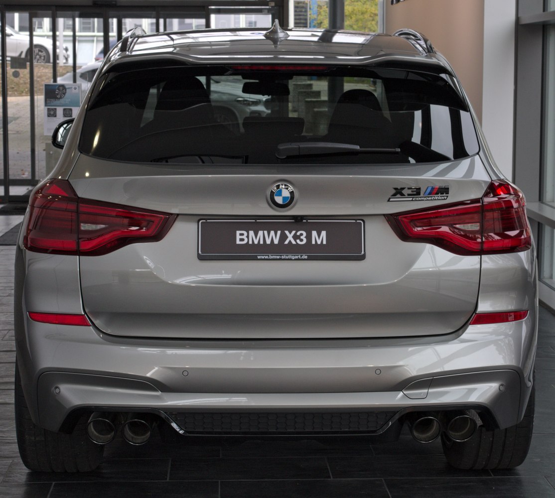 Rear view showing quad exhaust tips and distinctive taillights of a performance SUV